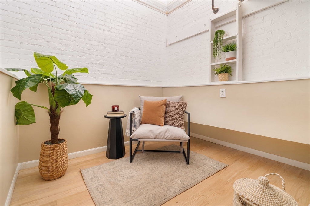 240 Heath Street, Unit PH16 Boston, MA 02130 - Photo 25 of 31 a living room with furniture flowerpot and wooden floor