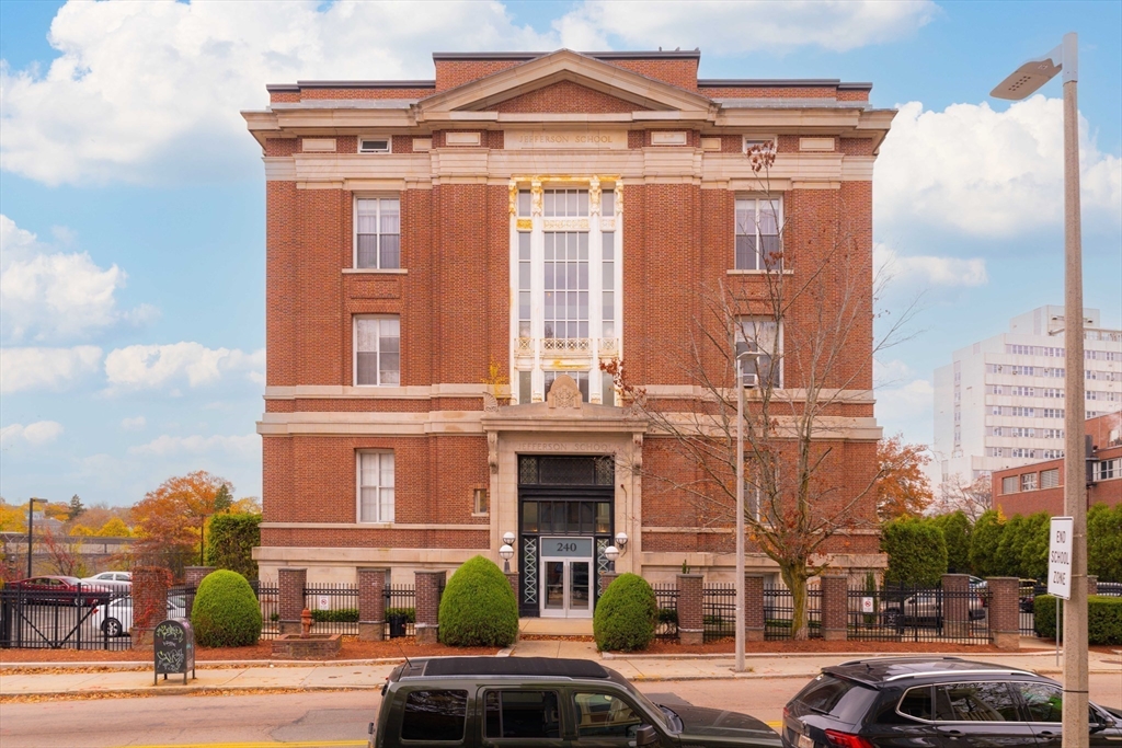 240 Heath Street, Unit PH16 Boston, MA 02130 - Photo 30 of 31 a front view of a residential apartment building with a yard