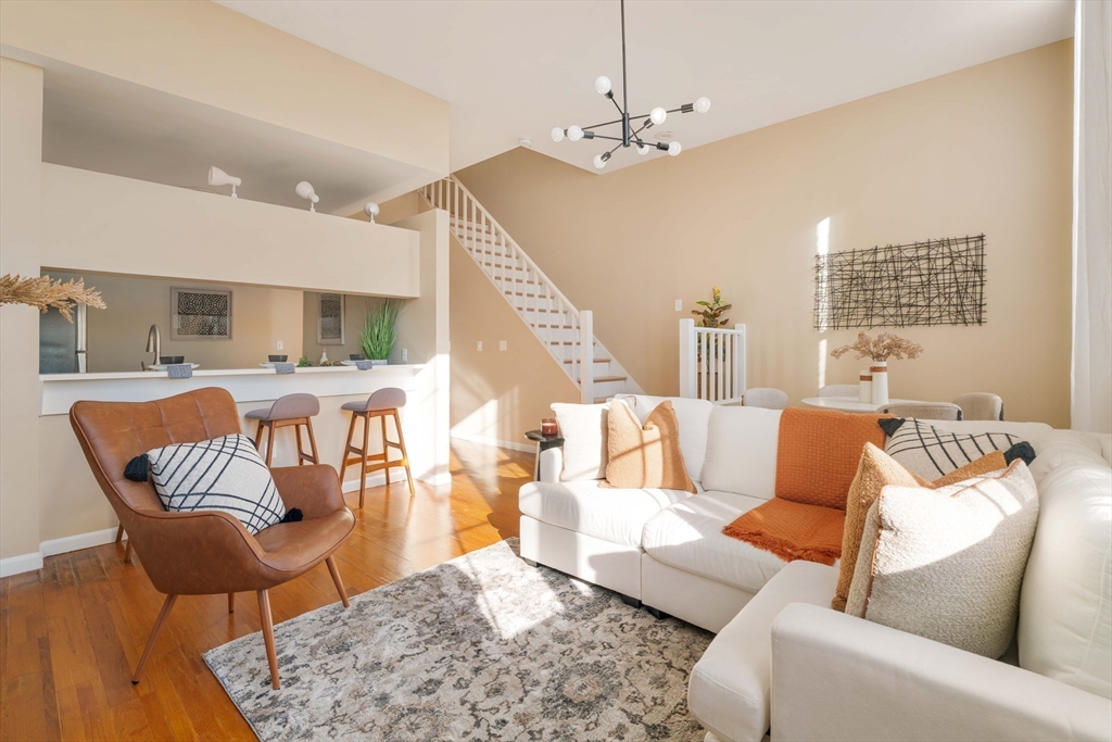 240 Heath Street, Unit PH16 Boston, MA 02130 - Photo 4 of 31 a living room with furniture and wooden floor