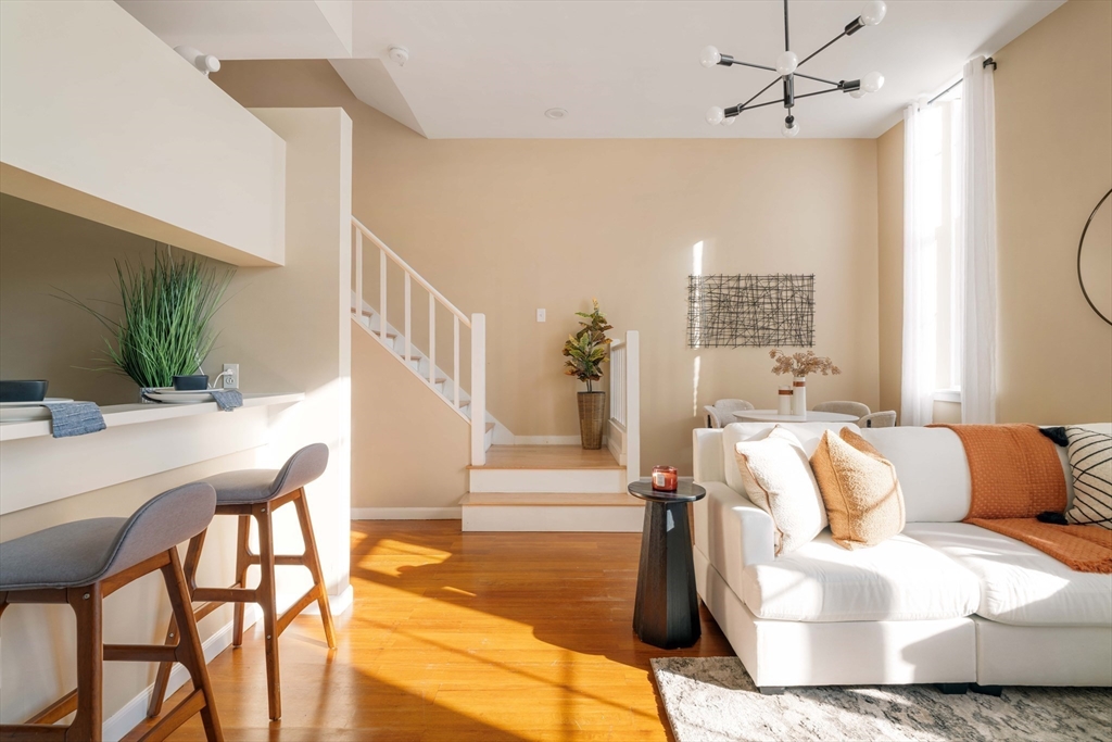 240 Heath Street, Unit PH16 Boston, MA 02130 - Photo 5 of 31 a living room with furniture and a table