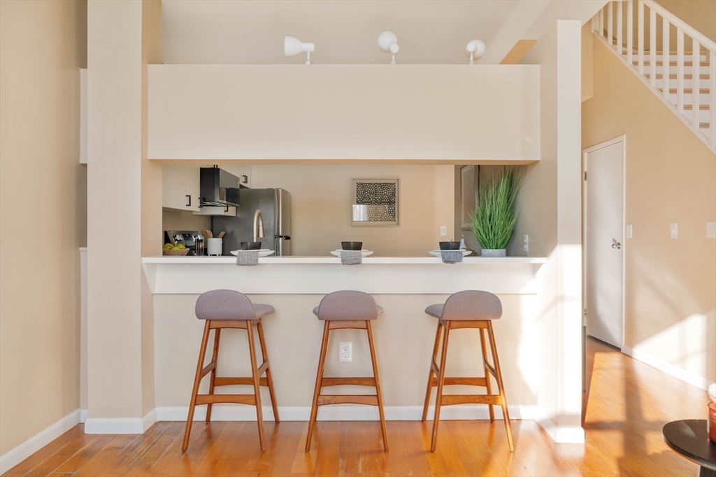 240 Heath Street, Unit PH16 Boston, MA 02130 - Photo 8 of 31 a kitchen with a table chairs refrigerator and sink
