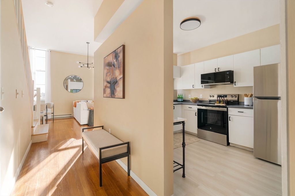 240 Heath Street, Unit PH16 Boston, MA 02130 - Photo 10 of 31 a kitchen with a refrigerator and a stove top oven