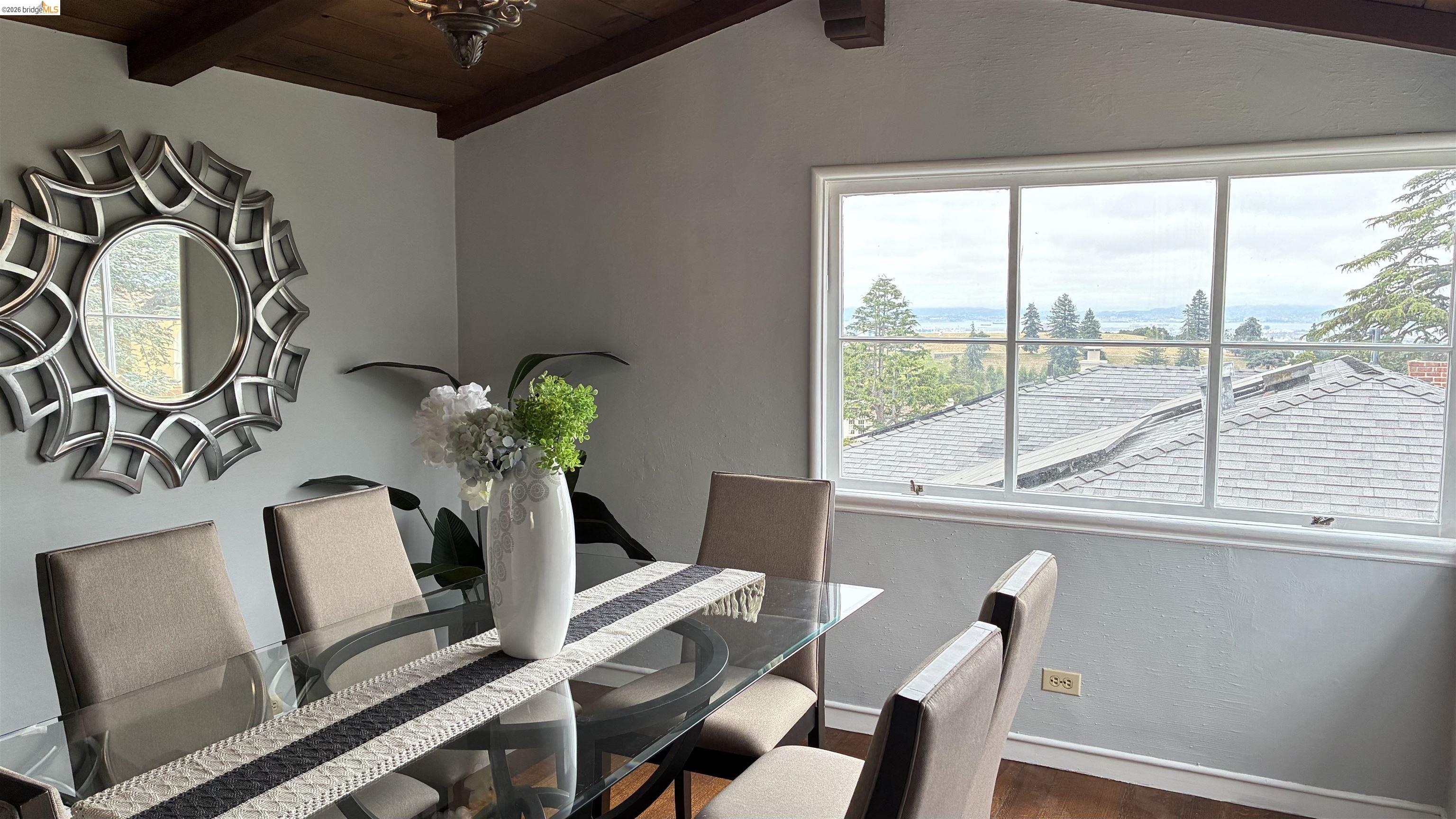 135 Alta Road Oakland, CA 94618 - Photo 14 of 42 Dining area featuring wooden ceiling, dark wood-style floors, and a textured wall