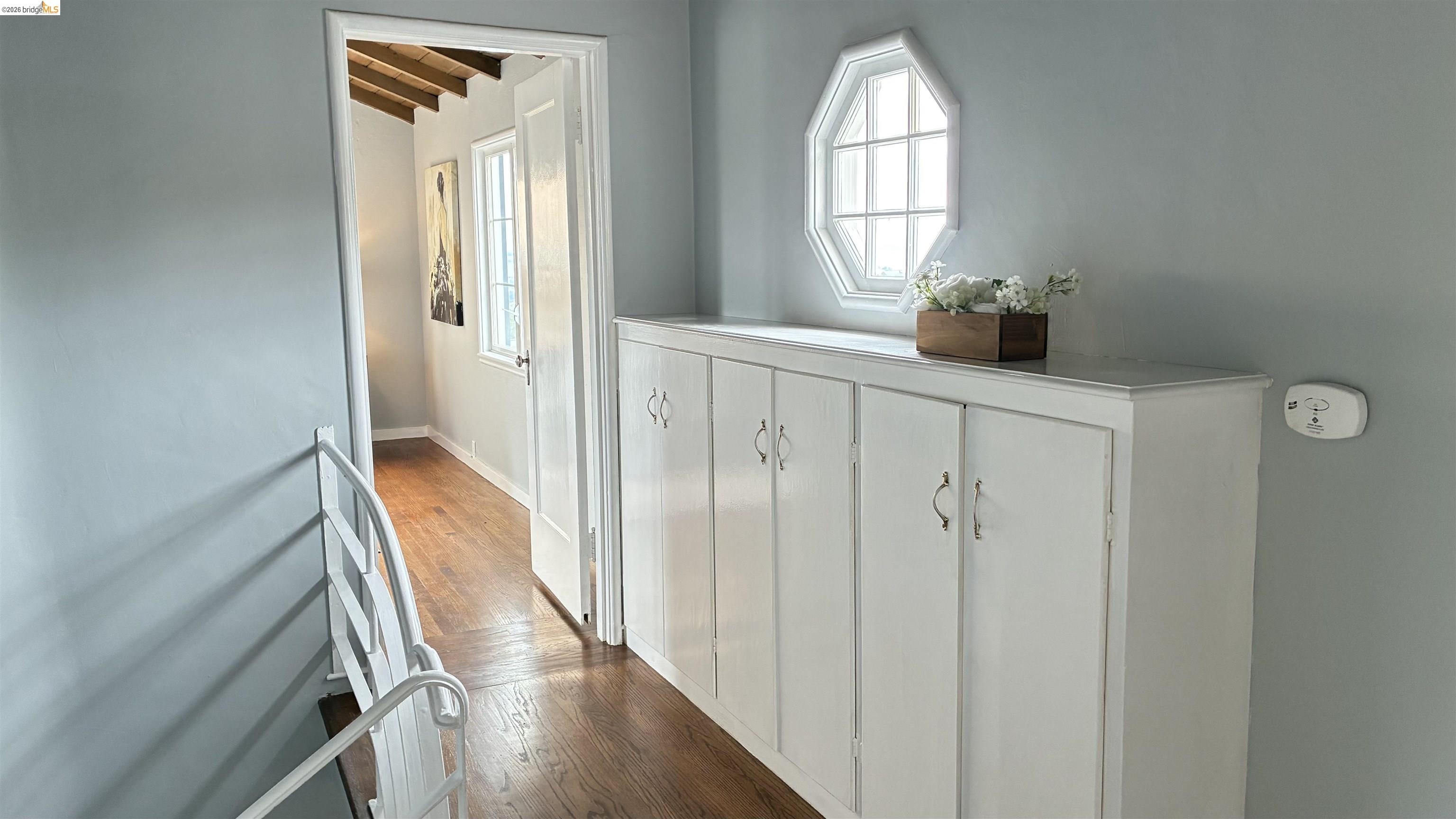 135 Alta Road Oakland, CA 94618 - Photo 23 of 42 Corridor with baseboards and dark wood finished floors