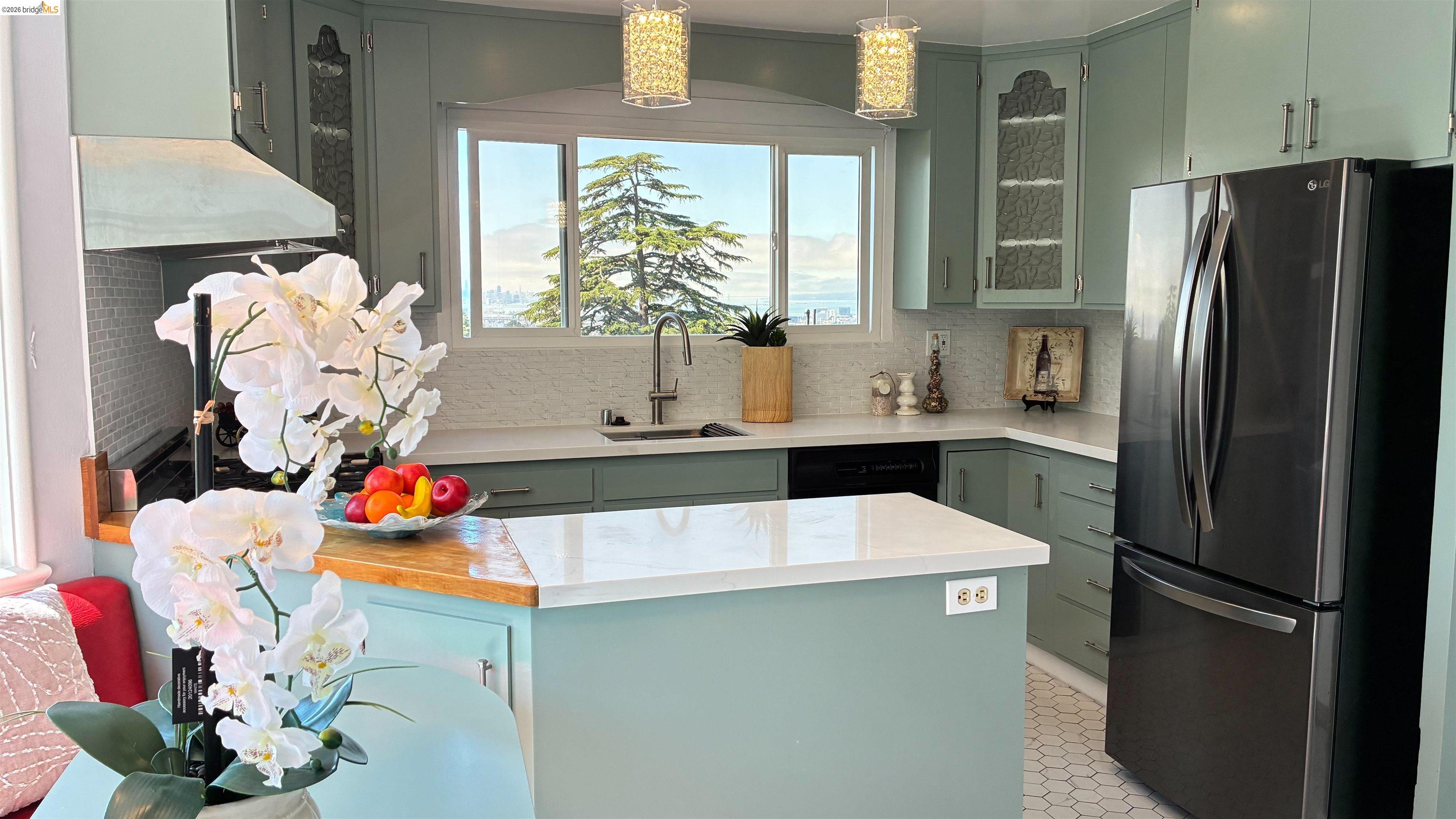 135 Alta Road Oakland, CA 94618 - Photo 8 of 42 Kitchen featuring freestanding refrigerator, decorative backsplash, glass insert cabinets, light stone countertops, and green cabinets