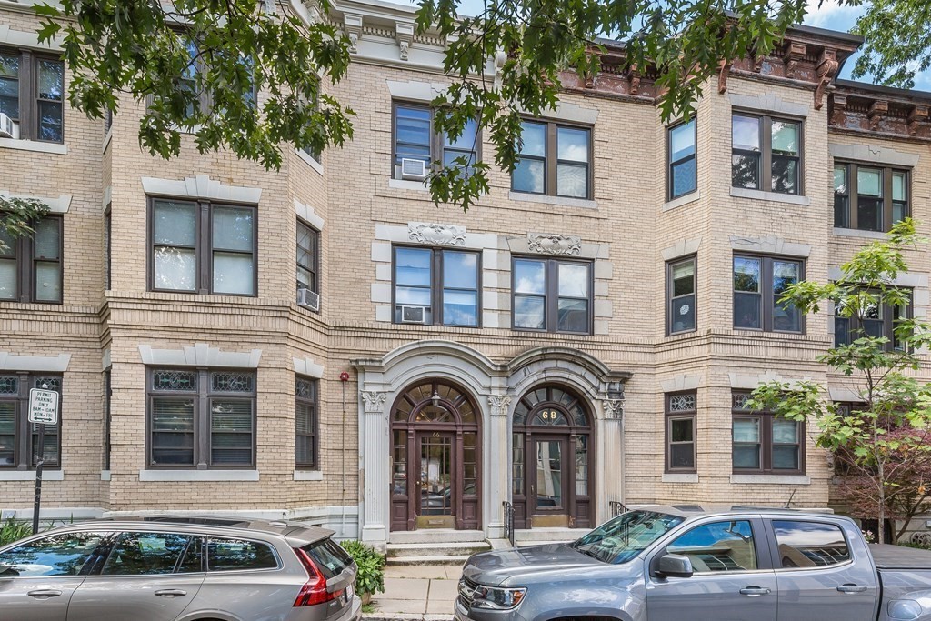a front view of a house with car parked