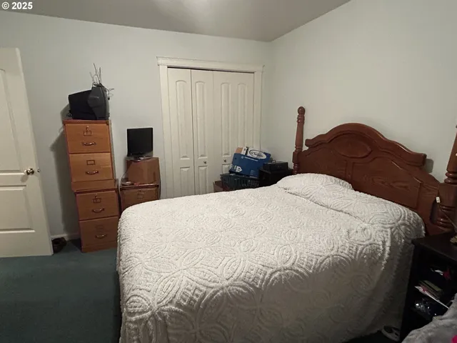 a bed sitting in a bedroom next to a window