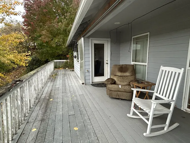 a balcony with furniture and wooden floor
