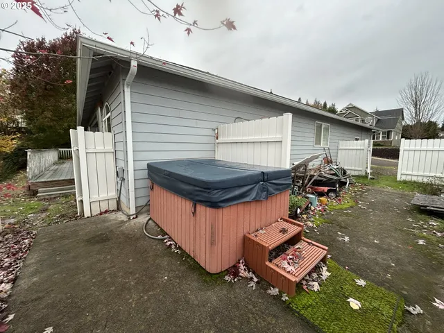 a backyard of a house with table and chairs