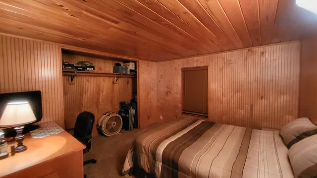 a bedroom with a bed and a desk