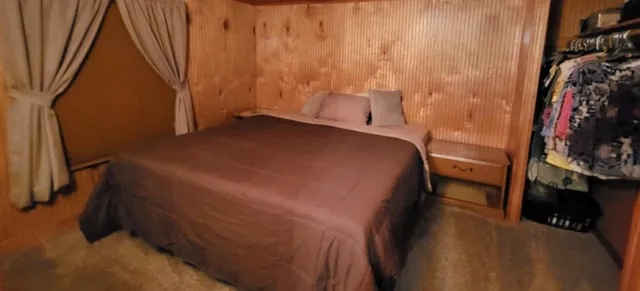 a bedroom with a bed and a walk in closet