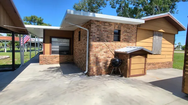 a view of a patio with table and chairs potted plants with wooden floor