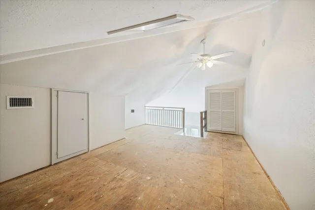 a view of an empty room with a ceiling fan