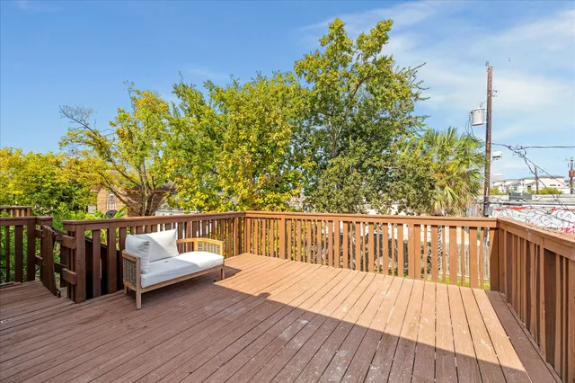 a view of balcony with wooden floor and seating space