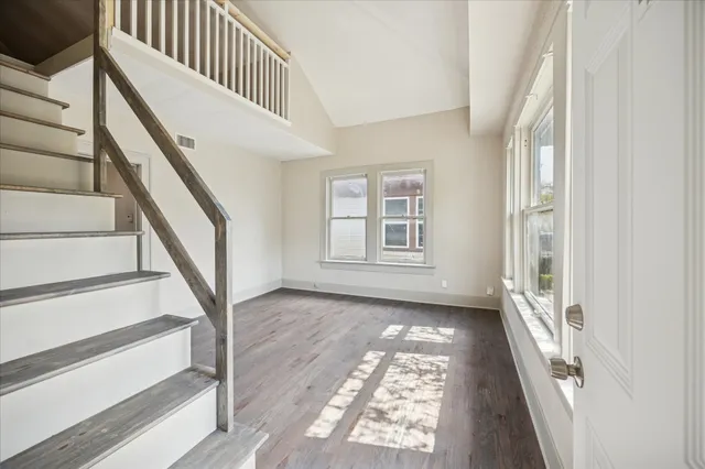 a view of an entryway with wooden floor