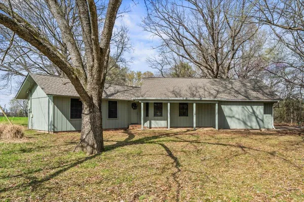 a house with trees in front of it