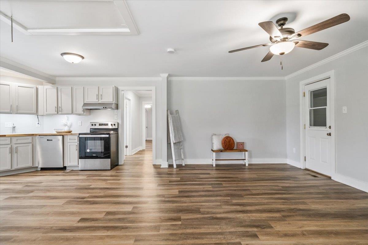 145 Quail Road Covington, TN 38019 - Photo 12 of 33 a living room with kitchen island a sink and a stove
