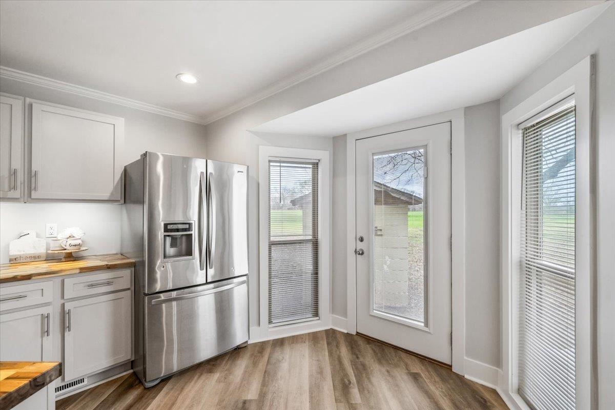 145 Quail Road Covington, TN 38019 - Photo 14 of 33 a kitchen with a refrigerator a microwave and cabinets