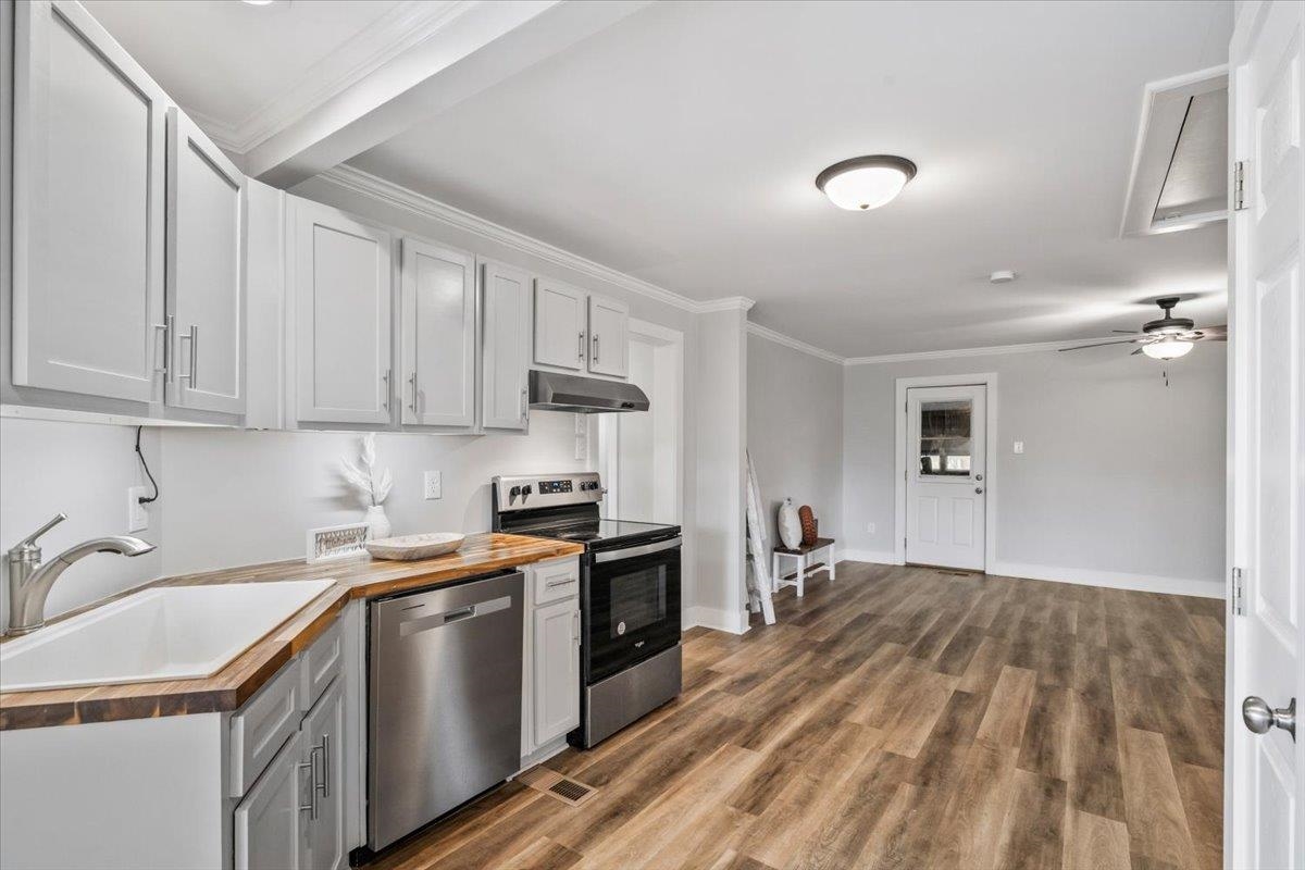 145 Quail Road Covington, TN 38019 - Photo 17 of 33 a kitchen with a sink stove and cabinets