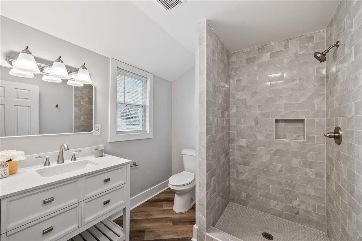 145 Quail Road Covington, TN 38019 - Photo 20 of 33 a bathroom with a double vanity sink toilet and shower