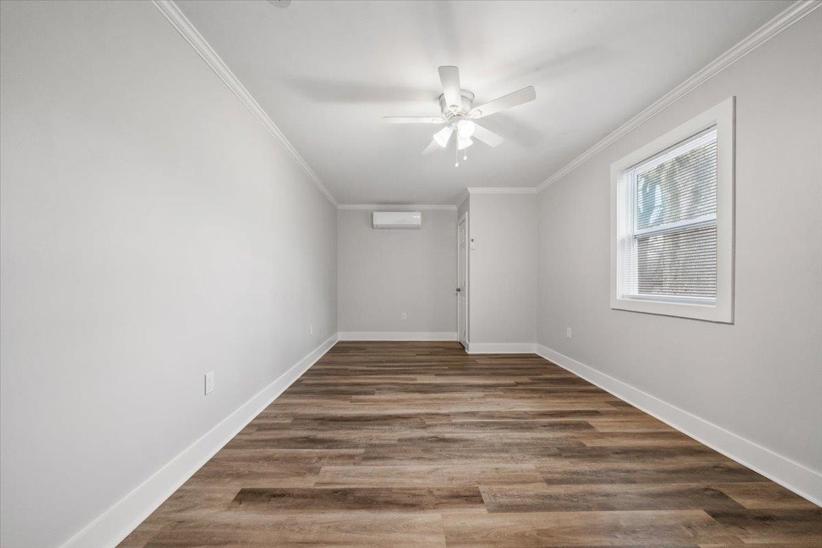 145 Quail Road Covington, TN 38019 - Photo 21 of 33 a view of an empty room with wooden floor and a window