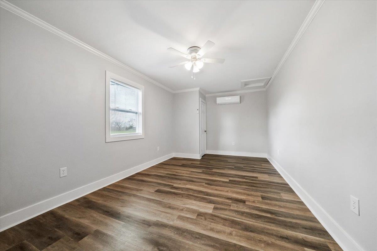 145 Quail Road Covington, TN 38019 - Photo 22 of 33 a view of empty room with wooden floor and fan