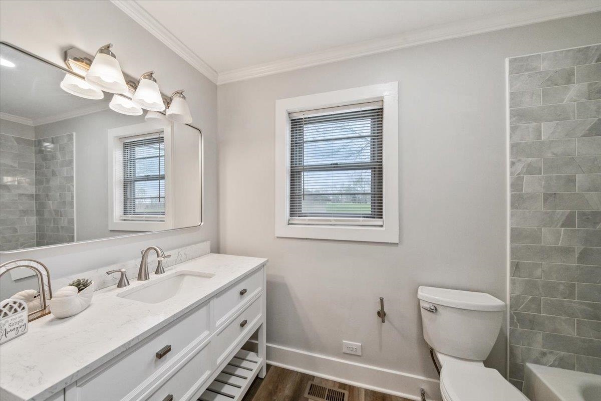 145 Quail Road Covington, TN 38019 - Photo 23 of 33 a bathroom with a sink a toilet and a mirror