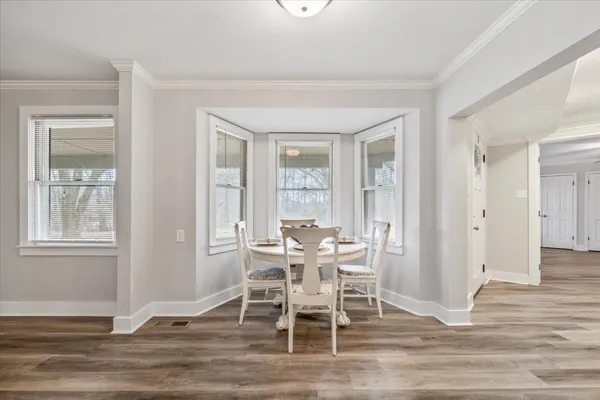 a view of a dining room with furniture window and wooden floor
