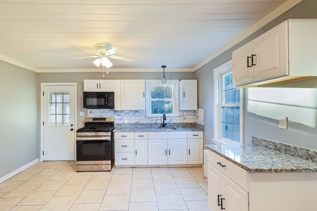 a kitchen with stainless steel appliances granite countertop a sink and stove top oven