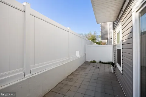 a picture of a bench in front of a wall