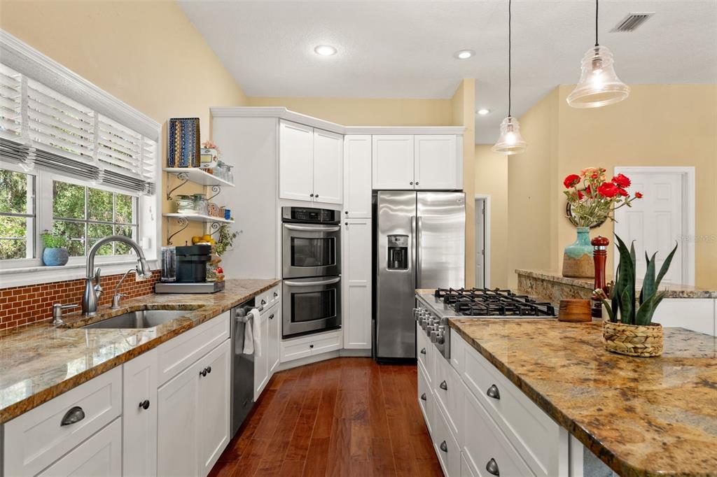 4270 Southeast 193rd Place Yankeetown, FL 34498 - Photo 11 of 42 a kitchen with stainless steel appliances granite countertop a sink a stove and a refrigerator