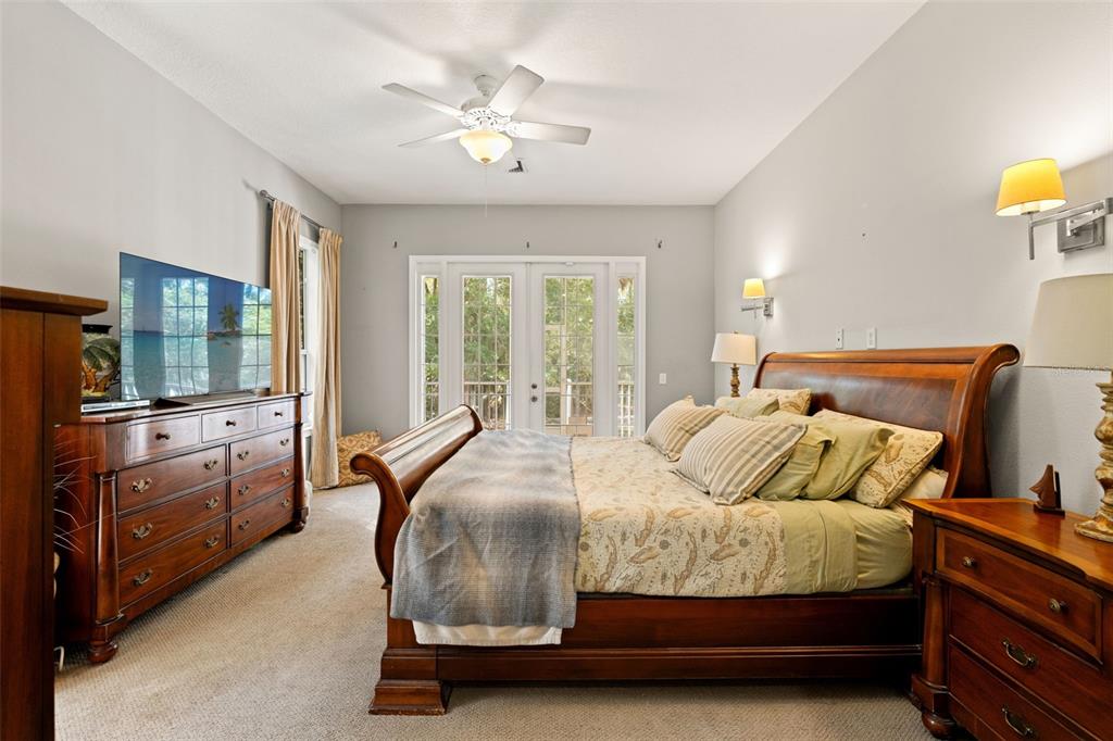 4270 Southeast 193rd Place Yankeetown, FL 34498 - Photo 14 of 42 a bedroom with a bed and a chandelier