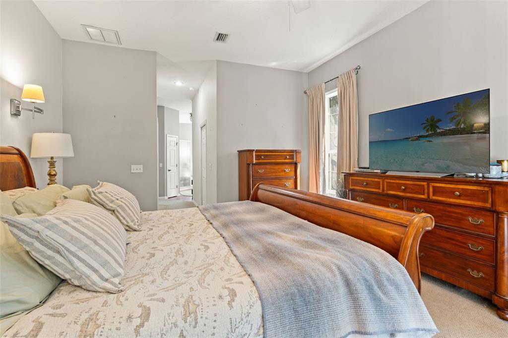 4270 Southeast 193rd Place Yankeetown, FL 34498 - Photo 15 of 42 a bedroom with a large bed and flat tv screen on dresser