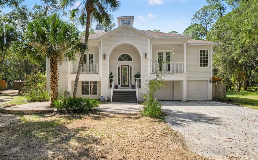 4270 Southeast 193rd Place Yankeetown, FL 34498 - Photo 2 of 42 a front view of a house with garden