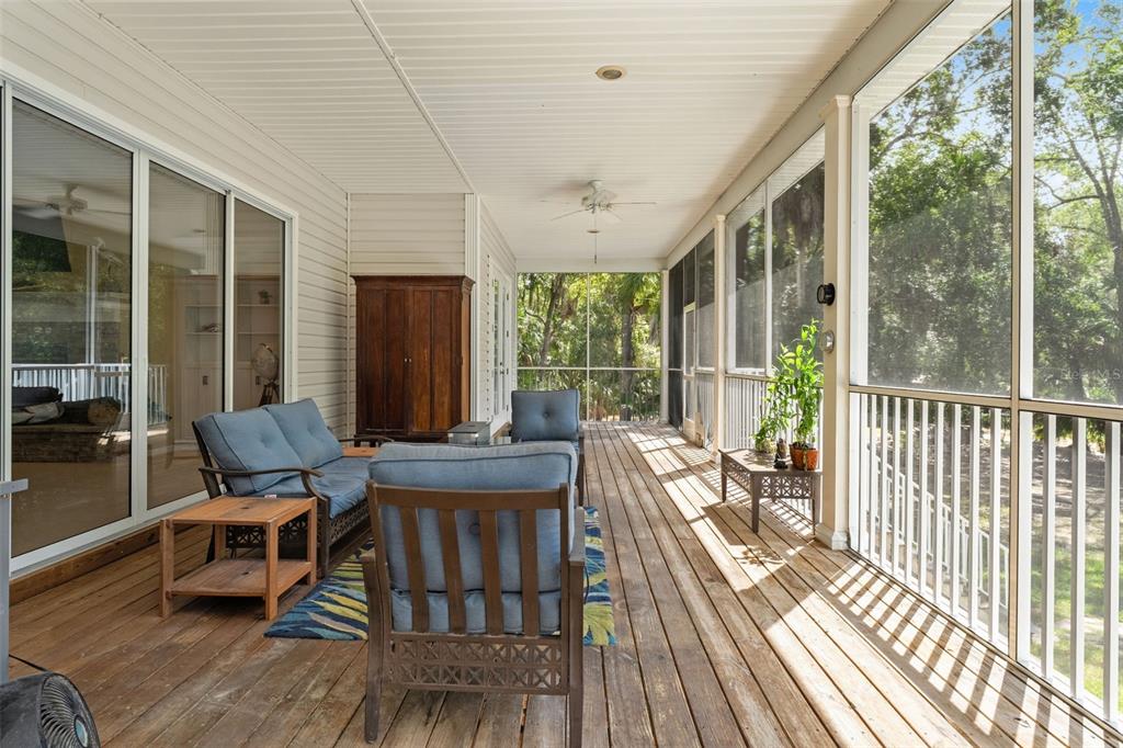 4270 Southeast 193rd Place Yankeetown, FL 34498 - Photo 22 of 42 a balcony with wooden floor and outdoor seating