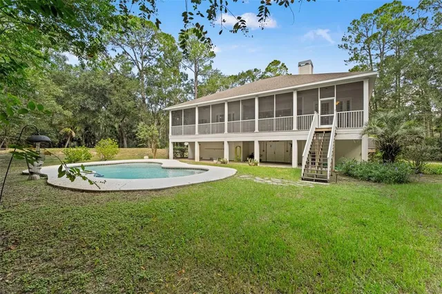 a view of a house with a yard and sitting area