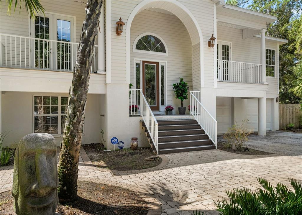 4270 Southeast 193rd Place Yankeetown, FL 34498 - Photo 41 of 42 a view of a brick house with plants and wooden fence