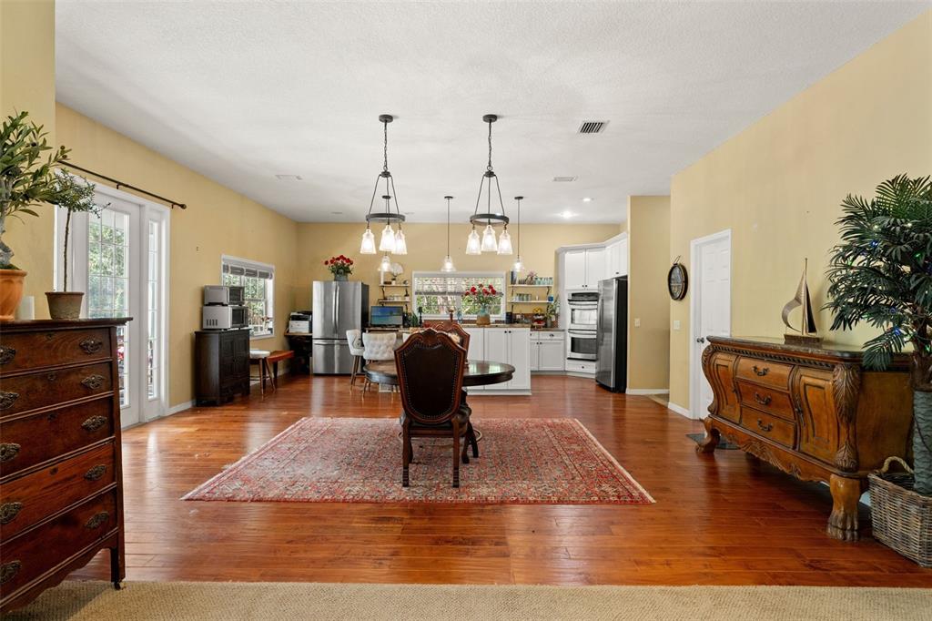 4270 Southeast 193rd Place Yankeetown, FL 34498 - Photo 8 of 42 a living room with furniture kitchen view and a wooden floor