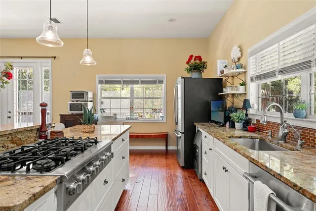 a kitchen with stove and refrigerator