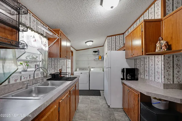 a kitchen with refrigerator and cabinets