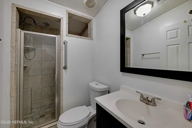 a bathroom with a sink a toilet and shower