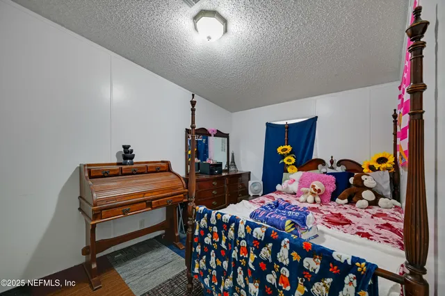 a bed room with two beds and a desk