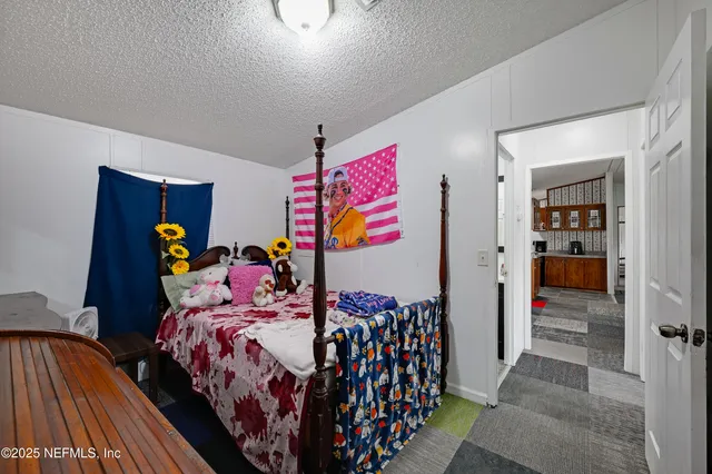 a bedroom with two beds and book shelf