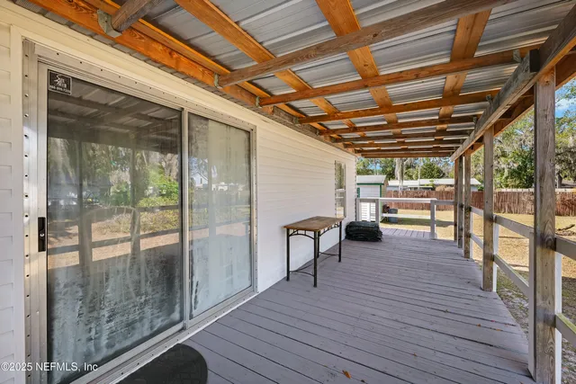 a view of a porch with wooden floor