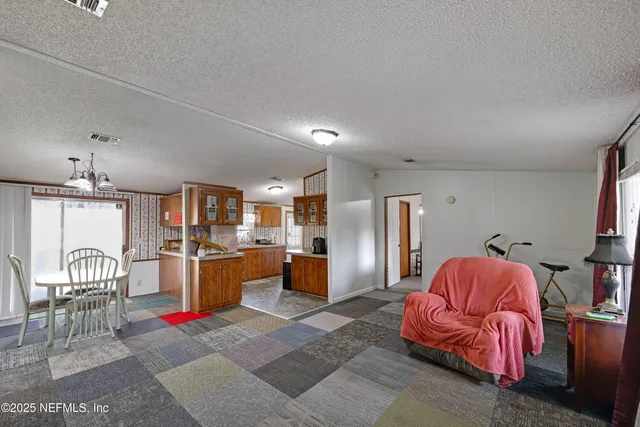 a living room with furniture fireplace and window
