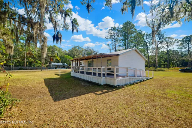 a view of a house with swimming pool and sitting area