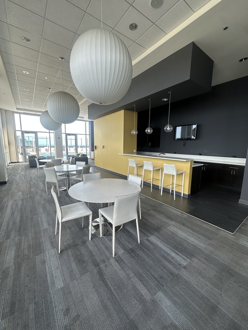 1901 South Calumet Avenue, Unit 2912 Chicago, IL 60616 - Photo 29 of 32 a view of a dining room with furniture and chandelier
