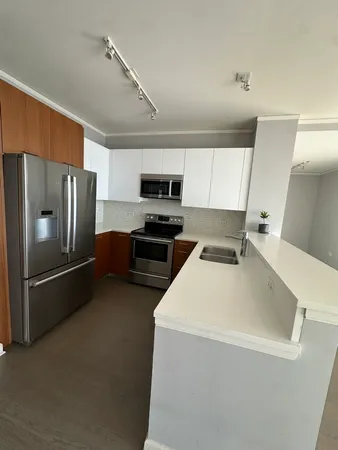 a kitchen with stainless steel appliances a refrigerator a stove a microwave and cabinets