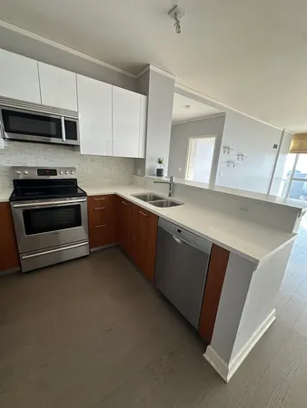 a kitchen with stainless steel appliances a sink stove and microwave