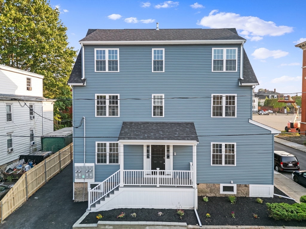 489 Spring Street Fall River, MA 02721 - Photo 1 of 42 a front view of a house with a yard
